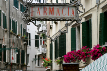 Fototapeta na wymiar Close up of pharmacy sign in Venice, Italy