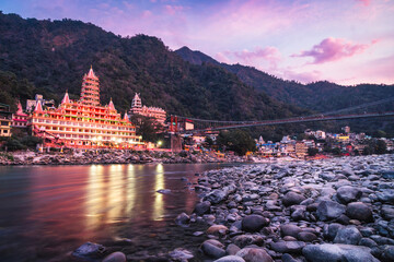 Rishikesh Yoga Capital of the World from ganga river side during a colorful sunset - obrazy, fototapety, plakaty