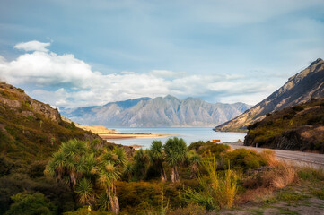 Curve in Highway 6 alpine road at 'the Neck' in-between Lakes Hawea and Wanaka, with mountain peaks...