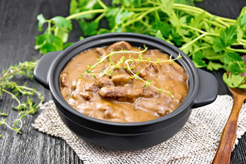 Goulash of beef in pan on dark board