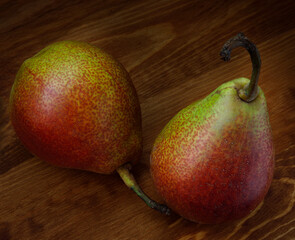 Two beautiful ripe pears on a wooden table.