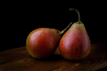 Two beautiful ripe pears on a wooden table.