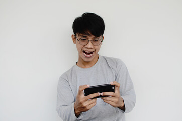 Portrait of an Asian man playing games on his cellphone
