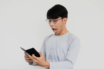 The Asian young man is shocked to see the wallet