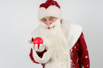Santa Claus holds a virus in his hands and smiles viciously.