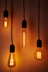 Set of a vintage light bulb on orange background. Glowing edison bulb
