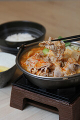 Traditional famous korean soup (kimji soup) made from tofu, chili paste, soup, pork, onion, egg, ferment bean and seasoning