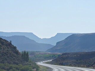 Virgin, Utah--July 2018: Winding road with the faint silhouettes of distant mountains Zion National...