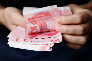 Man counts yuan. Currency of the China - One red hundred renminbi or yuan notes