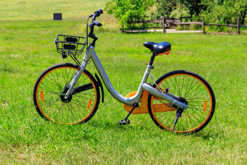 Fototapeta na wymiar Modern bicycle parked on a green lawn in rural area