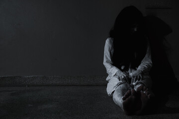 Horror woman ghost creepy sitting at the home, halloween day concept