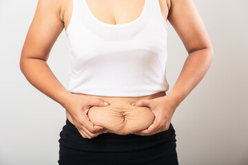 Close up of Asian mother woman showing stretch mark loose lower abdomen skin she fat after...