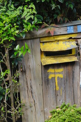 old mailbox on a wooden fence