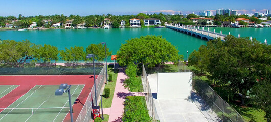 Miami, Florida. Aerial view of Palm Island and surrounding skyline from drone on a sunny day, slow motion.