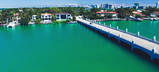 Miami, Florida. Aerial view of Palm Island and surrounding skyline from drone on a sunny day, slow motion.