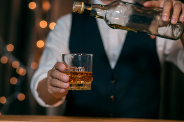 Barman pouring whiskey whiskey glass beautiful night