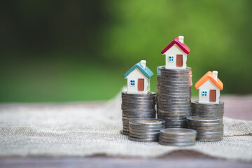 Mini house on stack of coins,Money and house,  Mortgage, Savings money for buy house and loan to...
