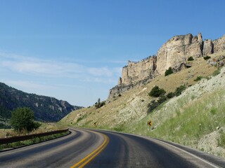 High wall cliffs along a winding scenic road at Bighorn Mountains in Wyoming.