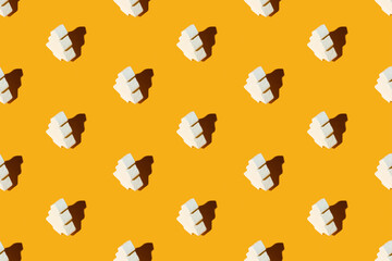 Orange Xmas background. Fir tree seamless pattern. Festive design. New Year party decorative arrangement. White ceramic ornament minimalist composition isolated on bright yellow.