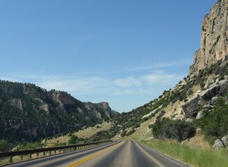 Scenic drive with geologic formations and cliffs through the Bighorn Mountains in Wyoming, USA.
