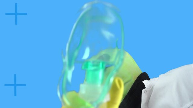 Shooting science fiction film about alien abduction for experiments and chipping, blue background. Humanoid runs to patient with anesthesia oxygen mask, bottom view.