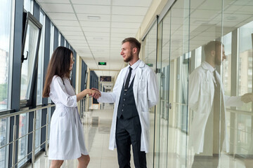 Beautiful young doctors are looking at camera in clinic