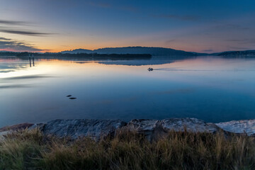 Clouds, reflections and sunrise over the bay