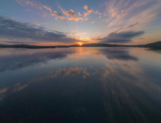 Sunrise waterscape with clouds and reflections