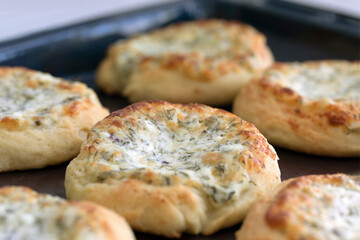 Homemade open patties with cheese and herbs. Traditional Russian pastry vatrushka, round buns.