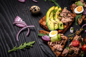 sandwich tuna fish salad on wholemeal bread on wooden background. Italian cuisine, Delicious breakfast or snack