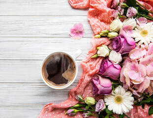 Pink flowers and cup of coffee