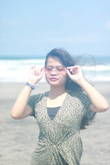 Outdoor lifestyle portrait of beautiful young asian woman on the beach.