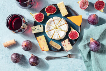 Cheese and wine tasting, cheese platter with figs, a flat lay, top shot