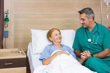 Doctor and elderly patient smile happily.