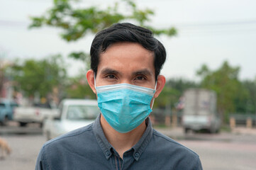 Asian man wear medical mask in lifestyle new normal to protect corona virus Covid 19