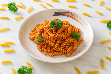spirali or spiral pasta with tomato sauce