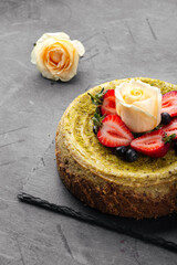 Pistachio cheesecake with berries and rose