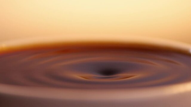 Black coffee drop into the filled Cup from the coffee machine in slow motion, Last drop of coffee drink