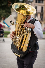 Musician of a brass band playing the Tuba during a city festival in the center of Padua, Veneto,...
