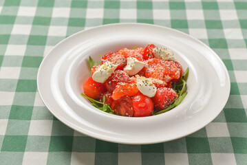Tomato and salmon salad with cheese and spices. Traditional Italian cuisine, Italian concept.