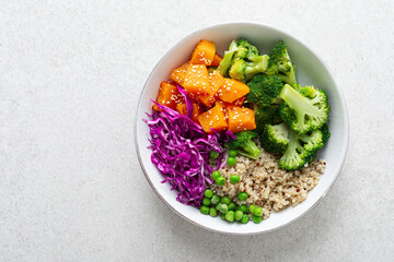 Vegetarian quinoa and broccoli lunch Buddha bowl with baked butternut squash or pumpkin, green peas...