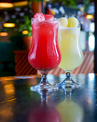 Refreshing passion fruit red and yellow juice in glasses. Delicious summer cocktails.