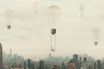surreal moment of a woman traveling on a swing carried by a light bulb over a metropolis - obrazy, fototapety, plakaty