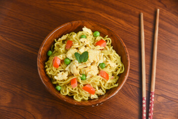 Vegetarian Schezwan Noodles Vegetable Hakka Noodles or Chow Mein in wooden bowl Schezwan Noodles is indo-chinese cuisine hot dish udon noodles Indonesian fried egg noodle. Indian Instant noodles ramen