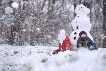 Kids walk in the park first snow