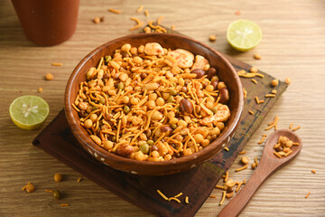 Traditional indian deep fried salty dish - chivda or mixture or farsan or namkeen made of gram flour and mixed with dry fruits. svouries otherwise called as masla mixture chakna with hot tea