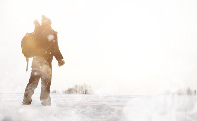 A man on a walk. Winter landscape. Tourist in winter journey.