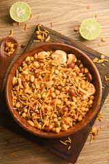 Traditional indian deep fried salty dish - chivda or mixture or farsan or namkeen made of gram flour and mixed with dry fruits. svouries otherwise called as masla mixture chakna with hot tea