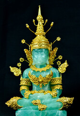 jade stone Buddha statue,  made  golden cover with shape,  jade stone Buddha statue with black background.