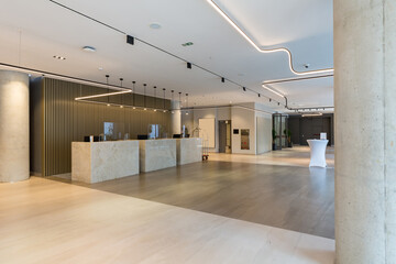 Interior of a hotel lobby with reception desks with transparent coronavirus guards